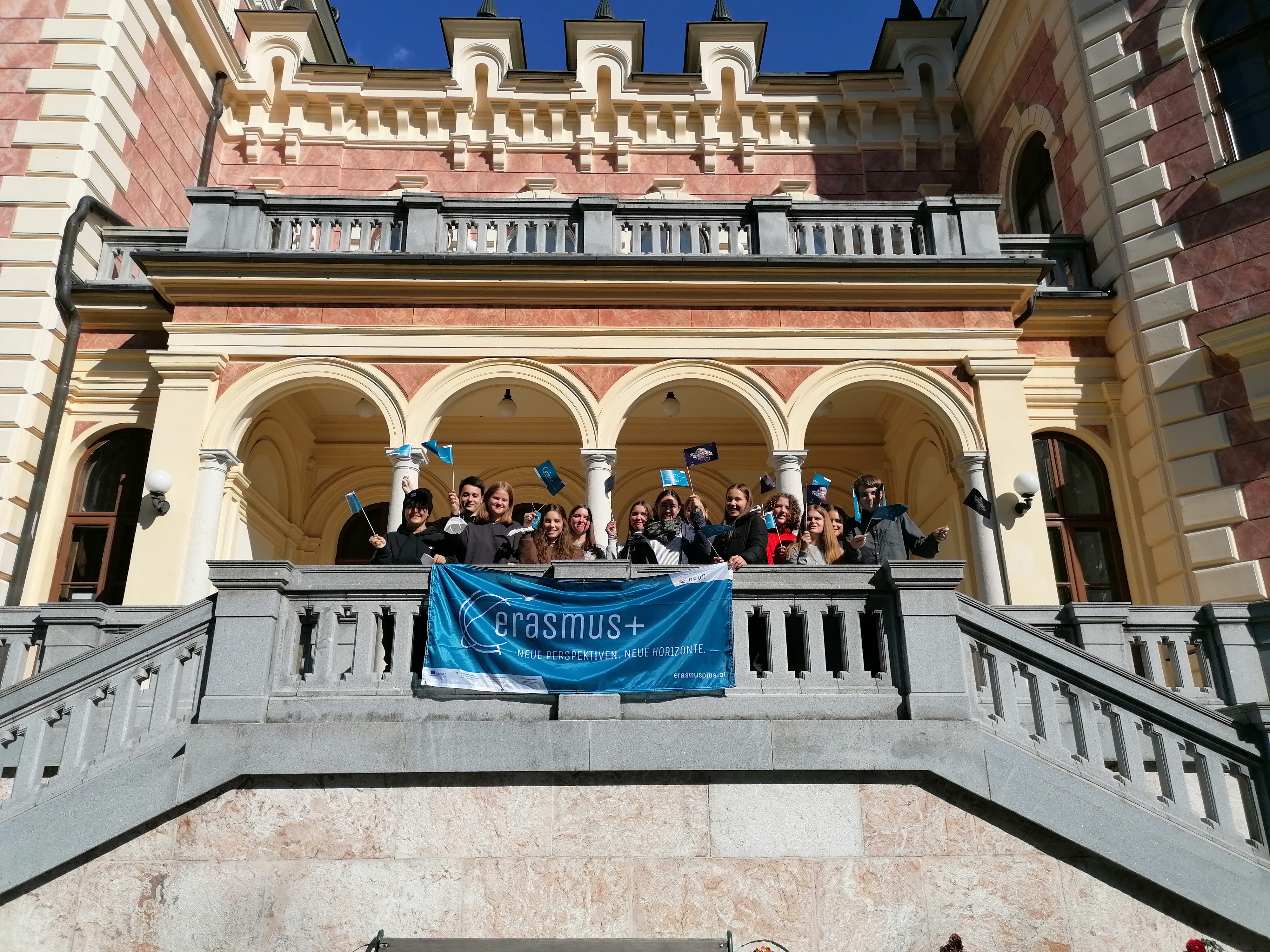 Schüler*innen mit Erasmus+ Transparent - Im Hintergrund das Schloss