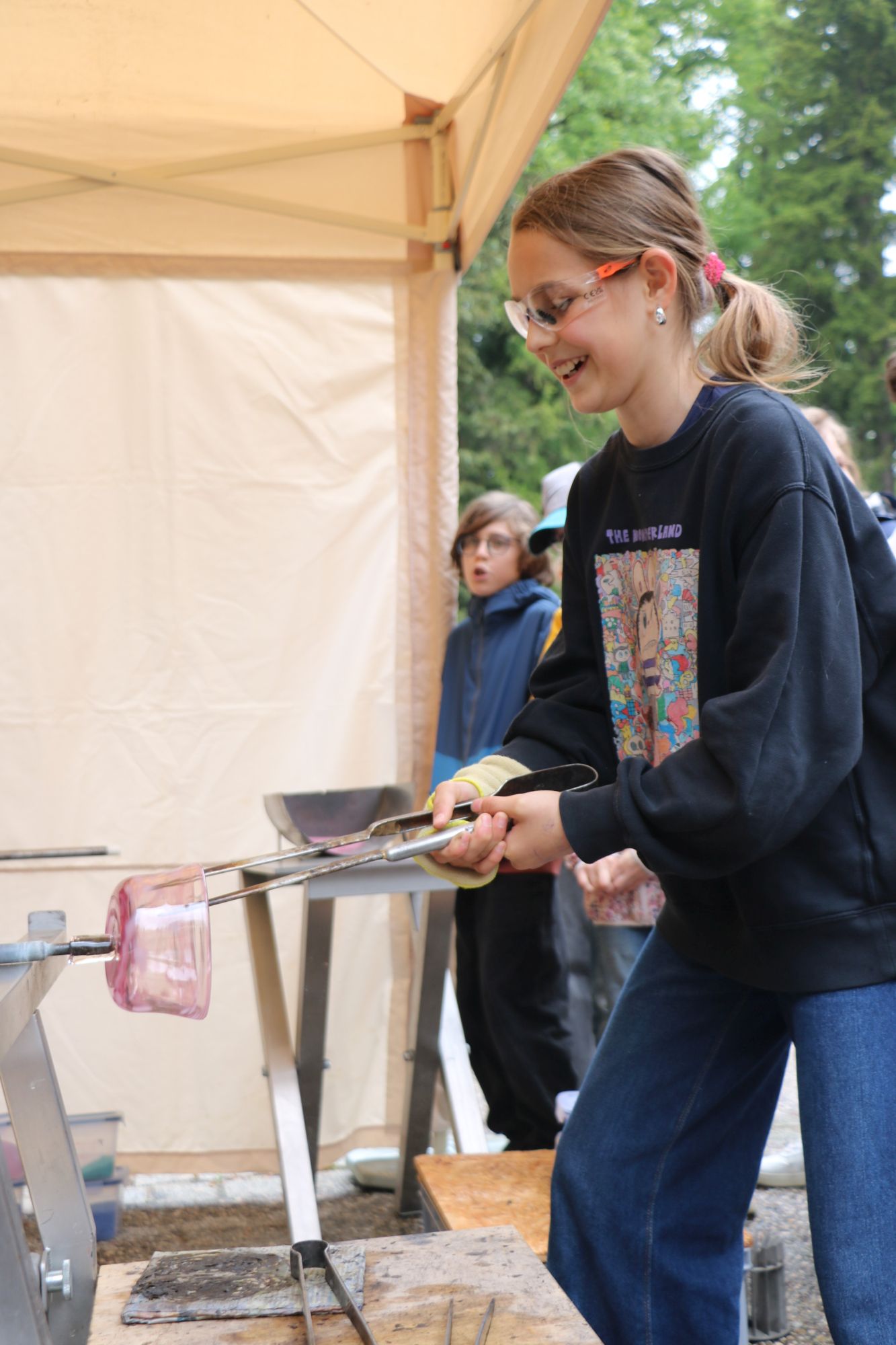 Schülerin nimmt an Glasbläserei Workshop teil
